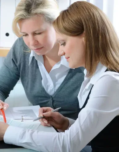 Two colleagues reviewing a business listing together
