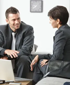 Two colleagues reviewing paperwork at a desk
